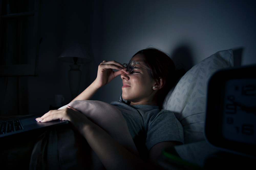 exhausted woman working late while home